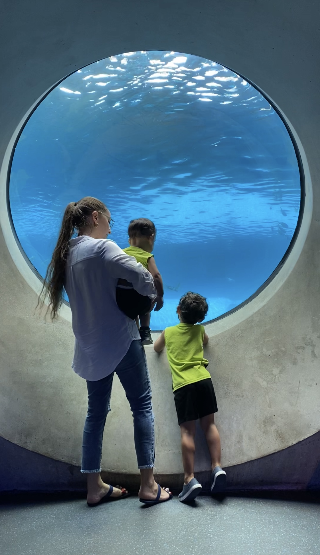 mother and sons in front of frost museum aquarium
