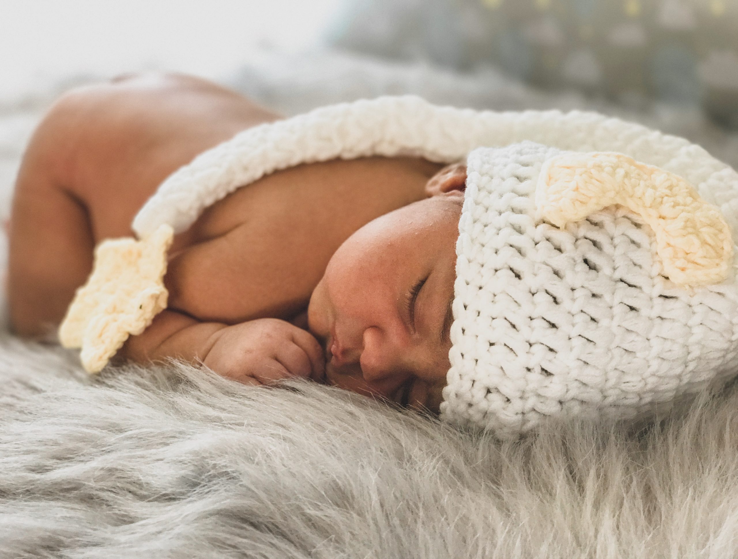 baby asleep with crocheted moon hat