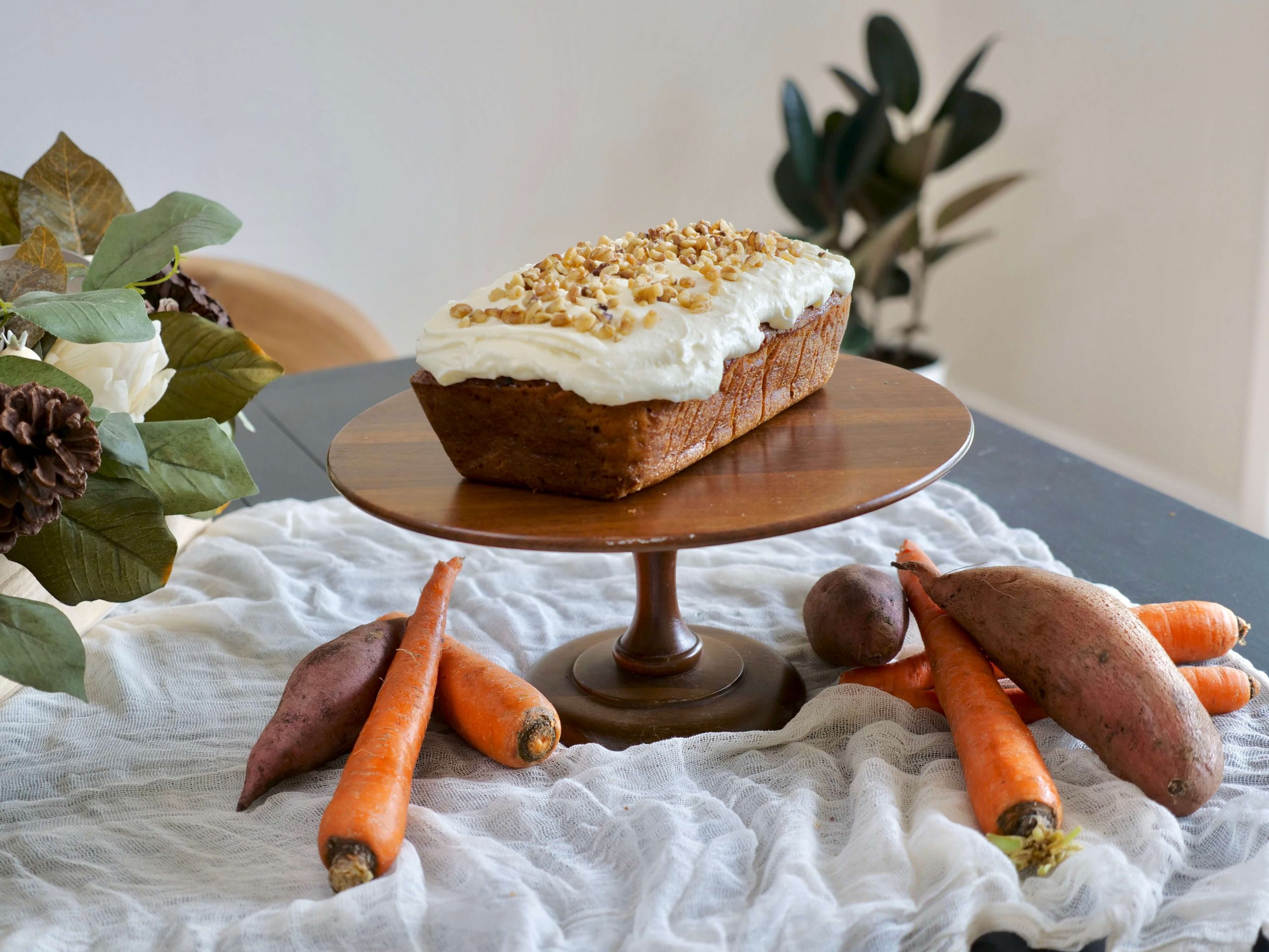 Carrot Sweet Potato cake on stand with frosting